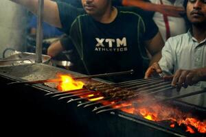 7th April 2023, Zakaria Street, Kolkata, West Bengal, India. Seekh Kebab Cooked on Charcoal at Zakaria Street during Eid al-Fitr photo