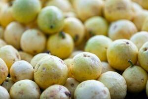 Stack Yellow Guavas on a market stall photo