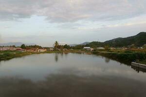 A village by the water with mountains in the background photo