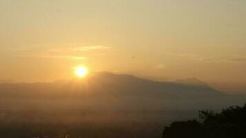 The sun rises over the mountains photo