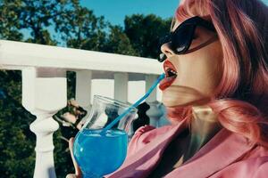 beautiful woman drinking a cocktail on the terrace unaltered photo