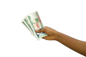 Fair hand holding 3D rendered Cuban peso notes isolated on transparent background png