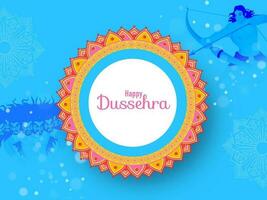 Happy Dussehra Lettering Over Mandala Frame With Lord Rama Taking An Aim Against Demon Ravana On Blue Bokeh Background. vector