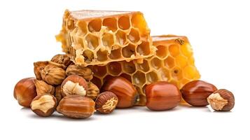 Honeycomb and multiple hazelnuts isolated on white background. Honey and nuts. Package design element with clipping path, photo
