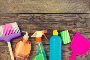 Cleaning products on wooden background. Toned image photo