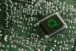 Environment green technology computer chip. Green world icon on circuit board technology innovations. Concept of green technology. Green Computing, Green Technology, Green IT, CSR, and IT ethics. photo