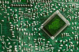 Environment green technology computer chip. Green world icon on circuit board technology innovations. Concept of green technology. Green Computing, Green Technology, Green IT, CSR, and IT ethics. photo