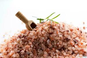 Himalayan pink salt is herb seasoning from himalaya and isolated on white background with copy space photo