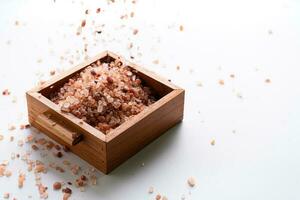 Himalayan pink salt is herb seasoning from himalaya and isolated on white background with copy space photo