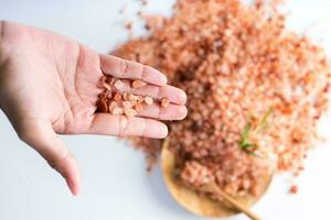 Himalayan pink salt is herb seasoning from himalaya and isolated on white background with copy space photo
