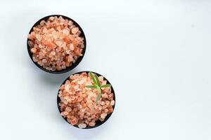 Himalayan pink salt is herb seasoning from himalaya and isolated on white background with copy space photo