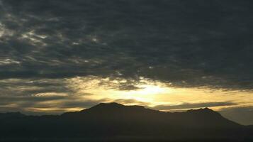 The sun rises over the mountains photo