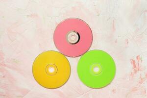 CD or DVD discs on pink background photo