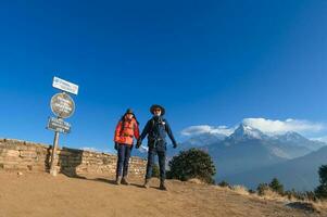 A young traveller trekking in Poon Hill view point in Ghorepani, Nepal photo