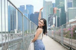 A young businesswoman is working in modern city downtown of Singapore photo