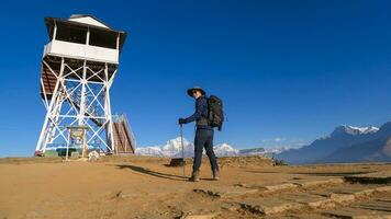 A young traveller trekking in Poon Hill view point in Ghorepani, Nepal photo