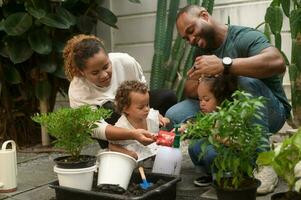 Happy African American family enjoying gardening at home photo