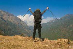 A young traveller trekking on forest trail , Nepal photo