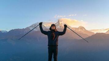 A young traveller trekking in Poon Hill view point in Ghorepani, Nepal photo