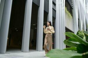 A young businesswoman is working in modern city downtown of Singapore photo