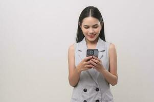 Beautiful woman using smartphone over white background, technology concept. photo