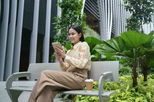 A young businesswoman is working in modern city downtown of Singapore photo