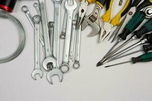 Set of tools for repair in a case on a white background. Assorted work or construction tools. Wrenches, Pliers, screwdriver. Top view photo