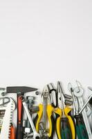 Set of tools for repair in a case on a white background. Assorted work or construction tools. Wrenches, Pliers, screwdriver. Top view photo