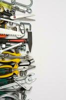 Set of tools for repair in a case on a white background. Assorted work or construction tools. Wrenches, Pliers, screwdriver. Top view photo