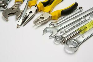 Set of tools for repair in a case on a white background. Assorted work or construction tools. Wrenches, Pliers, screwdriver. Top view photo