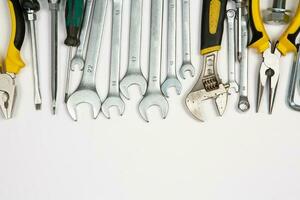 Set of tools for repair in a case on a white background. Assorted work or construction tools. Wrenches, Pliers, screwdriver. Top view photo