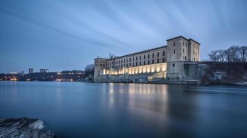 View of the hydroelectric power plant on the river, dusk, long exposure, photo