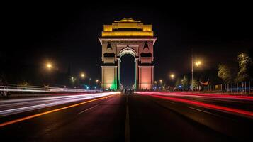 India gate at night with multicolored lights. This landmark is one of the main attractions of Delhi and a popular tourist destination. photo