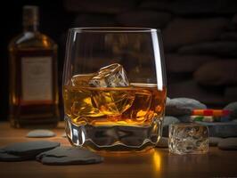 Glass of whiskey with ice cubes on the rock table, photo