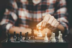 Planning and Decision concept, Businessman with strategy competitive ideas concept with chess board game. Business competition, Fighting and confronting problems, threats from surrounding problems. photo