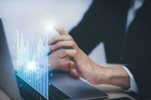 Business analytics and financial concept, Plans to increase business growth and an increase ,Technology and Business trend analysis concepts, with business graphs coming out on the computer notebook. photo