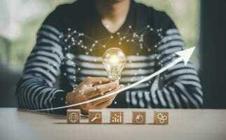 Concept brainstorming creative idea and innovation. thinking and creative, Close up the light bulb and wooden cube block with head human symbol and light bulb icon, people idea symbolized icons. photo