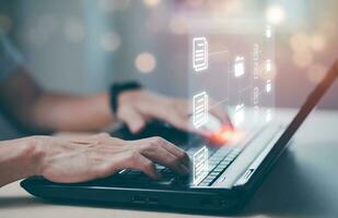 Online documentation database and document management system concept, Businessman using tablet or computer,Document Management System and Automation software to archiving and efficiently manage. photo