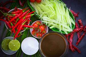 Thai food top view - papaya salad spicy with herbs and spices condiments and ingredients with chili tomato lemon lime papaya Slice, Thai Food photo