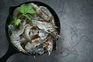 Raw shrimps prawns on ice bowl, Fresh shrimp seafood , white shrimp herbs and spice photo