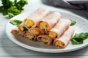Ham and cheese rolls on a plate. Delicious appetizer meat carbonate and cream cheese. photo