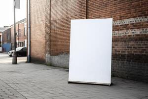 A blank white billboard mockup on a sidewalk in a city photo