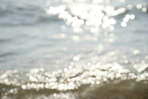 Abstract blurred bokeh background of sea and sand for design. photo