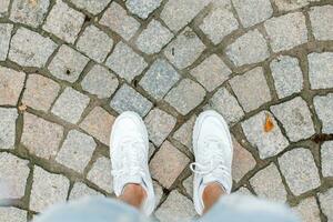 joven hombre de viaje en verano vacaciones. blanco zapatillas en teja. foto