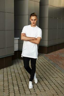 Premium Photo  Elegant young man in a fashionable black shirt in a white  stylish tshirt in black pants with a trendy hairstyle rests near a modern  business center attractive guy in