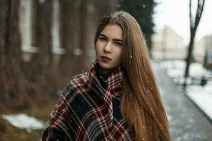 Beautiful young woman with a red scarf and coat on a winter day. photo