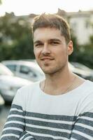 Portrait of a young handsome man with a smile. outdoors photo