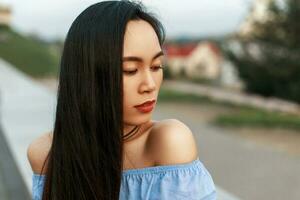 Beautiful female Asian face outdoors photo