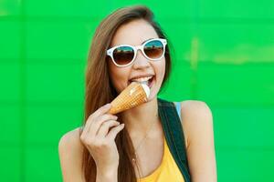 Happy beautiful cheerful woman with smile eats ice cream. photo