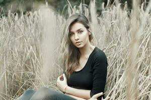 Woman in the dry grass. photo